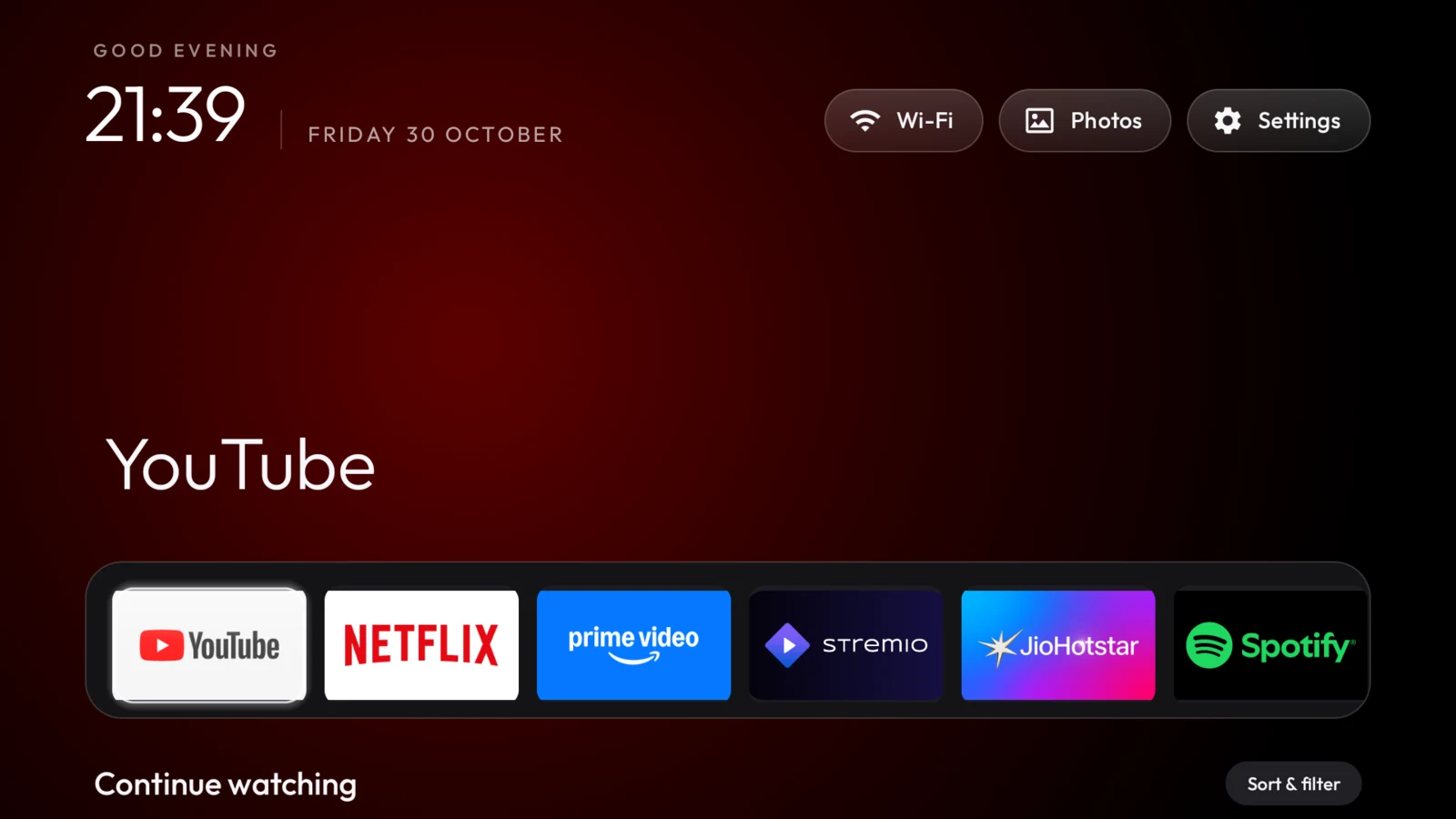 TV Shelves running on the TCL TV, with six pinned apps, the clock header and a Photos button beside Settings.